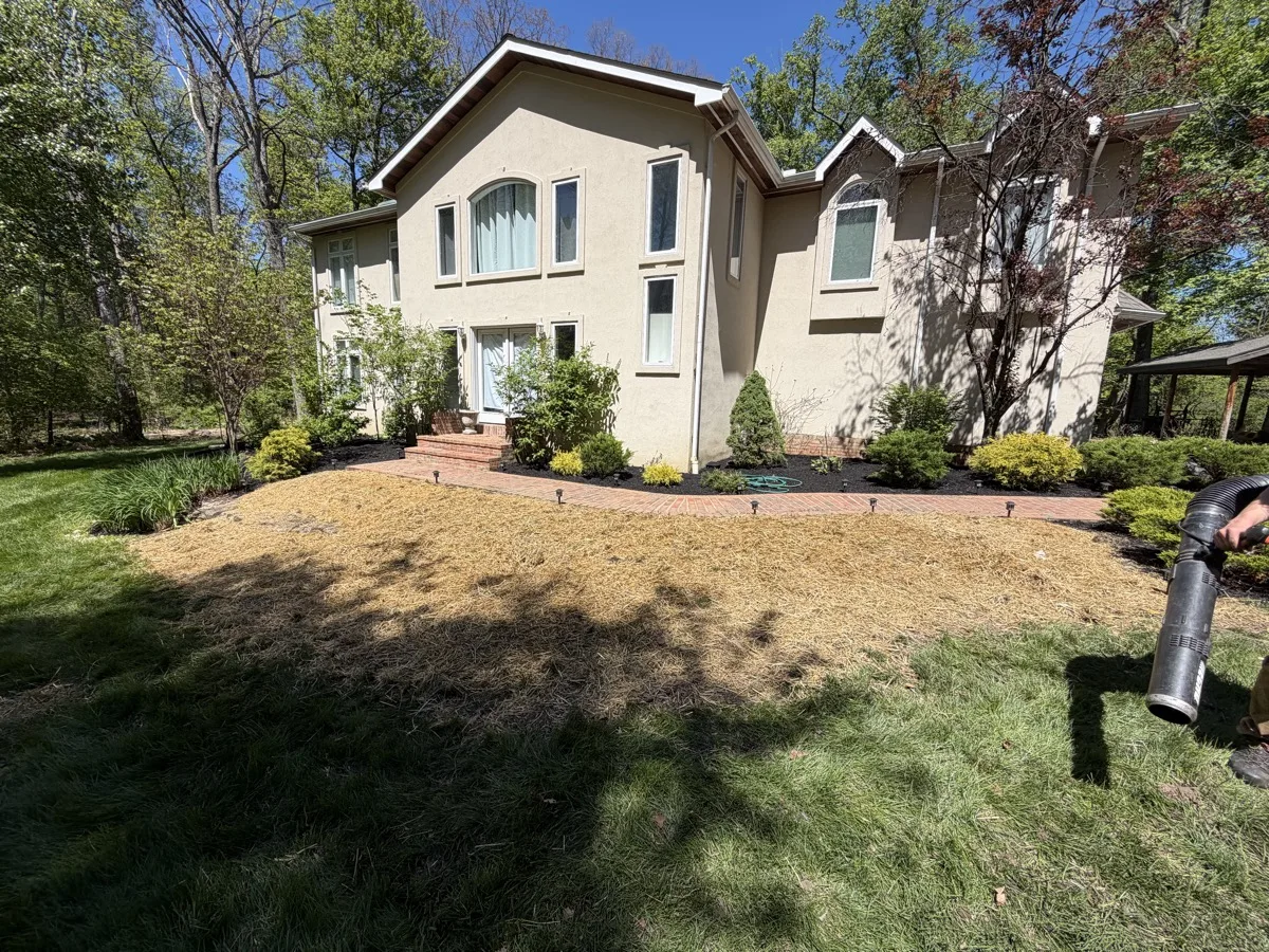 Completed foundation planting bed with a brick paver walkway installed by Bechtel's Landscaping